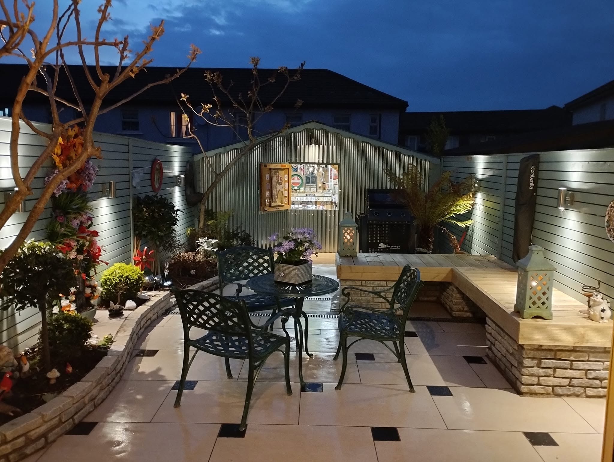 Tiled patio with garden bar and night lighting